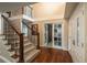 Grand foyer featuring hardwood floors, staircase with wrought iron, and stained glass-accented doors at 7750 S Glencoe Way, Centennial, CO 80122