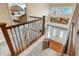 Bright foyer boasts wood floors, iron banister, chandelier, and glass-paneled double doors at 7750 S Glencoe Way, Centennial, CO 80122