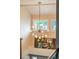 Foyer features a modern chandelier, large windows, and colorful artwork at 7750 S Glencoe Way, Centennial, CO 80122