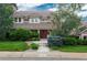 Charming two-story home with manicured lawn and mature trees, creating inviting curb appeal at 7750 S Glencoe Way, Centennial, CO 80122