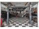 Spacious garage featuring a checkered floor and a car lift for the car enthusiast at 7750 S Glencoe Way, Centennial, CO 80122