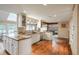 Spacious kitchen with an island, modern lighting, and hardwood floors open to a living space at 7750 S Glencoe Way, Centennial, CO 80122