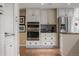 Gourmet kitchen area with stainless steel appliances, granite countertops, and custom cabinets at 7750 S Glencoe Way, Centennial, CO 80122