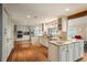 Spacious kitchen with custom cabinets, stainless appliances, granite countertops, and wood floors at 7750 S Glencoe Way, Centennial, CO 80122