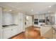 Open kitchen with stainless steel appliances, granite counters, gas cooktop, and abundant counter space at 7750 S Glencoe Way, Centennial, CO 80122