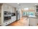 Bright, renovated kitchen with stainless steel appliances, granite countertops, skylight and attached dining area at 7750 S Glencoe Way, Centennial, CO 80122