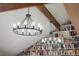 Custom library featuring ceiling beams, two chandeliers, and built-in bookshelves at 7750 S Glencoe Way, Centennial, CO 80122