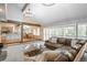 Spacious living room with vaulted ceilings, exposed beams, and an open layout into the kitchen at 7750 S Glencoe Way, Centennial, CO 80122
