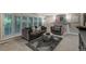 Comfortable living room showcasing neutral paint, fireplace, shuttered windows, and plush seating at 7750 S Glencoe Way, Centennial, CO 80122