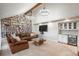 Stylish living room with a custom bookshelf, wet bar, comfortable seating, and vaulted ceilings at 7750 S Glencoe Way, Centennial, CO 80122