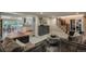 Open-concept living space with elegant staircase, view to kitchen, and comfortable, plush furnishings at 7750 S Glencoe Way, Centennial, CO 80122