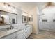 Main bathroom features a dual sink vanity, marble countertops, and a walk-in shower at 7750 S Glencoe Way, Centennial, CO 80122