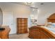 Main bedroom includes custom wood furniture, white walls, and entry to the bathroom at 7750 S Glencoe Way, Centennial, CO 80122
