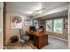 Bright office space with built-in shelving, a large desk, and natural light from shuttered windows at 7750 S Glencoe Way, Centennial, CO 80122