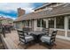 A charming outdoor patio features a table and chairs, inviting relaxation and gatherings at 7750 S Glencoe Way, Centennial, CO 80122