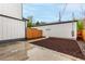 Exterior view of the backyard area featuring a white house and landscaping at 1463 Dahlia St # 2, Denver, CO 80220