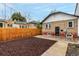 Backyard area with a brick house, wood fence, and landscaping at 1463 Dahlia St # 2, Denver, CO 80220