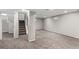 Spacious carpeted basement with painted walls and stairs to upper level at 1463 Dahlia St # 2, Denver, CO 80220