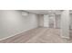 Carpeted basement with freshly painted walls and doorway to another room at 1463 Dahlia St # 2, Denver, CO 80220