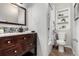 Bathroom featuring a dark wood vanity, tiled backsplash, and shower with decorative curtain at 1463 Dahlia St # 2, Denver, CO 80220
