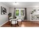 Dining room features a glass table, stylish lighting, and hardwood floors at 1463 Dahlia St # 2, Denver, CO 80220