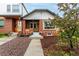 Charming brick home with a cozy front porch and landscaped front yard at 1463 Dahlia St # 2, Denver, CO 80220