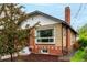 A charming brick home with a large window and neat landscaping at 1463 Dahlia St # 2, Denver, CO 80220