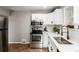 Bright, modern kitchen showcasing stainless steel appliances, white cabinetry, and stylish countertops at 1463 Dahlia St # 2, Denver, CO 80220