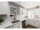 Bright kitchen featuring white cabinets, stainless steel appliances, and modern fixtures and finishes at 1463 Dahlia St # 2, Denver, CO 80220