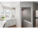 Updated kitchen with stainless steel appliances, white cabinets, and a view to the backyard at 1463 Dahlia St # 2, Denver, CO 80220