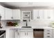 Updated kitchen featuring white cabinets, modern hardware, stainless appliances, and stylish countertops at 1463 Dahlia St # 2, Denver, CO 80220