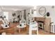 Bright living room with hardwood floors, fireplace, and view to the dining area at 1463 Dahlia St # 2, Denver, CO 80220