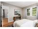 Neutral-toned main bedroom featuring a large window and stylish decor at 1463 Dahlia St # 2, Denver, CO 80220