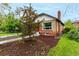 A beautifully landscaped yard with a tree adds to the curb appeal of the home at 1463 Dahlia St # 2, Denver, CO 80220