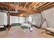 Unfinished basement, ideal for a golf practice area, with exposed ceiling and white plastic-covered walls at 4781 Basalt Ridge Cir, Castle Rock, CO 80108