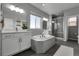 Contemporary bathroom features a soaking tub, glass-enclosed shower, and dual sink vanity at 4781 Basalt Ridge Cir, Castle Rock, CO 80108