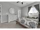 Well-lit bedroom with neutral walls and carpet, a ceiling fan, and decorative patterned bedding at 4781 Basalt Ridge Cir, Castle Rock, CO 80108