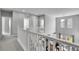 Bright upstairs hallway with white railings overlooks dining area and offers lots of natural light at 4781 Basalt Ridge Cir, Castle Rock, CO 80108