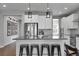 Modern kitchen island with stainless steel appliances, bar seating, and decorative pendant lights at 4781 Basalt Ridge Cir, Castle Rock, CO 80108