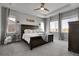 Spacious primary bedroom features tray ceilings, multiple windows, and an attached ensuite bathroom at 4781 Basalt Ridge Cir, Castle Rock, CO 80108