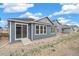 View of the backyard of a home with blue siding and white trim at 13392 E 110Th Way, Commerce City, CO 80022