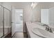 Bathroom featuring double sinks, large mirror, and walk-in shower with glass doors at 13392 E 110Th Way, Commerce City, CO 80022