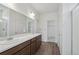 Spacious bathroom with double sinks, walk-in shower with glass doors, and vanity at 13392 E 110Th Way, Commerce City, CO 80022