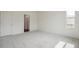Spacious bedroom with ensuite bathroom, walk in closet, and neutral carpet at 13392 E 110Th Way, Commerce City, CO 80022