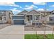 Charming single-Gathering home featuring a covered porch, well-kept lawn, and a two-car garage at 13392 E 110Th Way, Commerce City, CO 80022