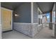 Inviting front porch with stone accents, a bright yellow door, and ample space for relaxing at 13392 E 110Th Way, Commerce City, CO 80022