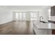 Spacious living and kitchen area featuring modern island, stainless steel appliances, and lots of natural light from the windows at 13392 E 110Th Way, Commerce City, CO 80022