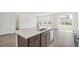 An elegant kitchen island is the focal point, offering ample space for cooking, dining, and entertaining at 13392 E 110Th Way, Commerce City, CO 80022