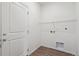 Bright laundry room features sleek wood-look flooring and modern hookups at 13392 E 110Th Way, Commerce City, CO 80022