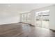 Bright living room with large windows and sliding glass door to yard with luxury vinyl plank flooring at 13392 E 110Th Way, Commerce City, CO 80022